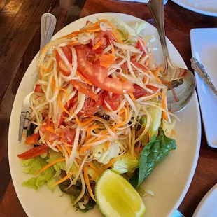 Papaya salad, as a Thai person, I asked for super spicy. She brought a sample out for me and I asked for more chilies!