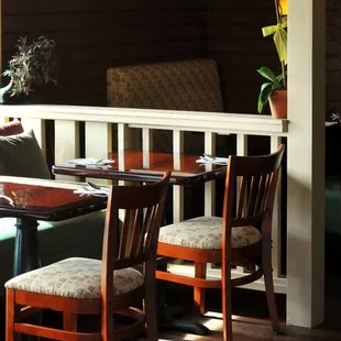 a dining area with a table and chairs