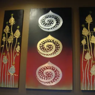 three paintings on the wall