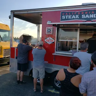 a group of people ordering food from a food truck