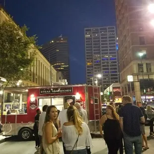 a group of people standing on a city street
