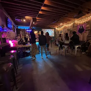 people standing and sitting at tables