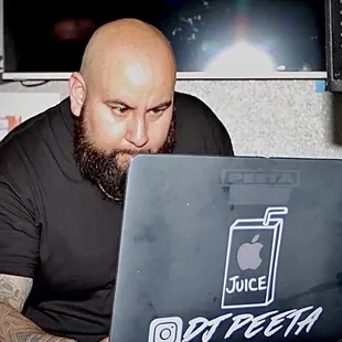 a bald man working on a laptop