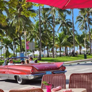 a classic car driving down the street