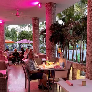 The cozy pink outdoor dining overlooking Ocean Drive