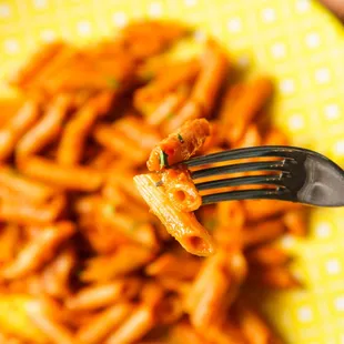 a fork in a bowl of pasta