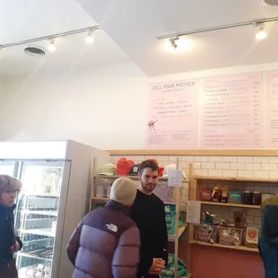 Refrigerator grab and go, shelves of CYM merch and foods