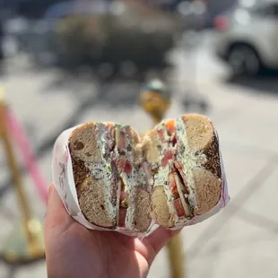 a hand holding a sandwich