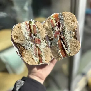 a hand holding a sandwich