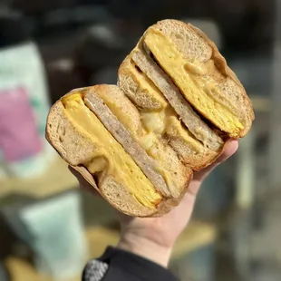 a hand holding a sandwich