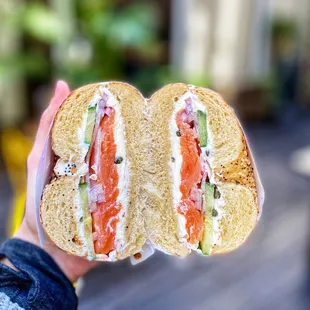 a person holding a sandwich