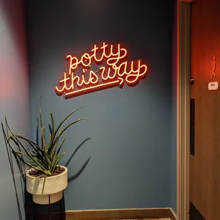 Bathrooms are on the same side as the Call Your Mother counter