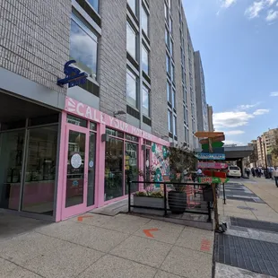 The exterior of Call Your Mother, which has some tables and chairs to sit down at.