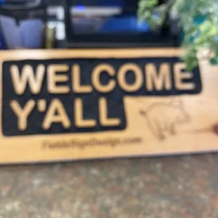 a welcome sign on a counter