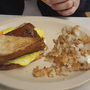 Livermush, egg, and cheese sandwich with hash browns and onions.