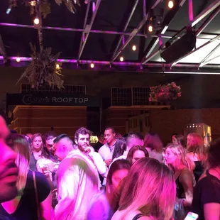a crowd of people dancing at a party