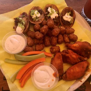 Sampler Platter: wings, onion rings, potato skins, veggie sticks, and dipping sauces. We got tator tots instead of onion rings.