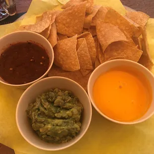 Trio Chips: tortilla chips with three dipping sauces; roasted red pepper, guacamole, and cheese.