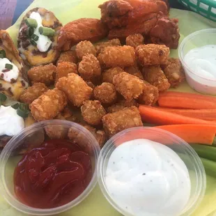 Sampler Platter: wings, onion rings, potato skins, veggie sticks and dipping sauces. We swapped the rings for tator tots.