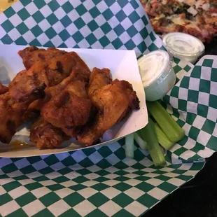 Charred wings and pizza.