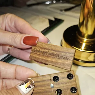 a woman&apos;s hand holding a wooden object