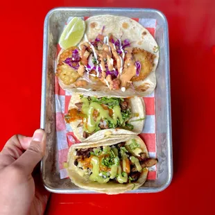 a person holding a tray of food