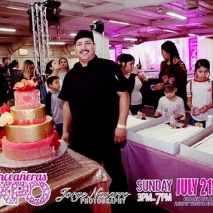 a man standing in front of a cake