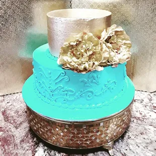 a three tiered cake with flowers on top