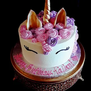 a unicorn cake with pink and purple frosting