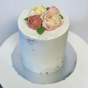 a white cake with flowers on top