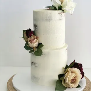 a three tiered cake with flowers on top