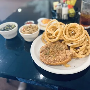 Fried pork chop w/greens and cornbread dressing.  Some homemade onion rings.