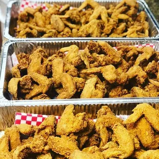 trays of fried chicken on a table