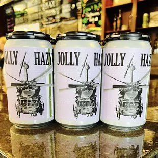 three cans of beer on a bar counter
