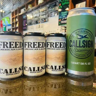 three cans of beer on a bar