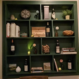 a table with a wine bottle and wine glasses on it