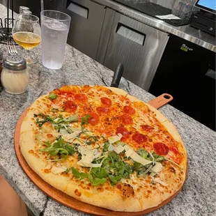Half arugula/ half pepperoni pizza