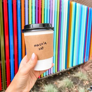 a hand holding a cup of coffee