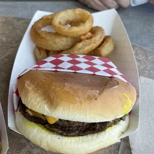 Double cheeseburger, mustard, pickle. Onion rings.