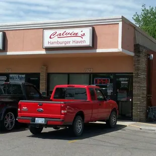 two trucks parked in front of a restaurant