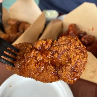 a fork picking up a piece of fried chicken