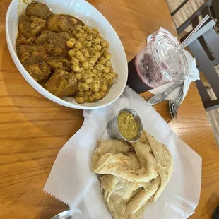Chicken curry, chickpeas, roti, hot sauce, hibiscus  tea
