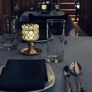 a table setting with silverware and glassware