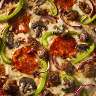 pepperoni, mushrooms, and onions on a pizza