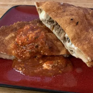 a red plate with meat and sauce