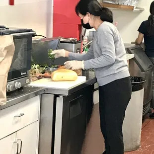 a woman preparing food in a kitchen
