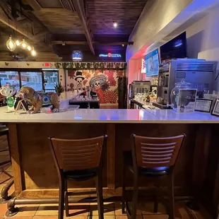 a bar with chairs