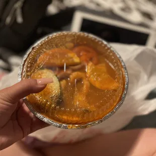 a person holding a bowl of soup