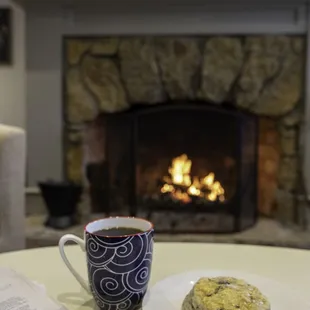 Enjoy a cup of coffee by our fireplace
