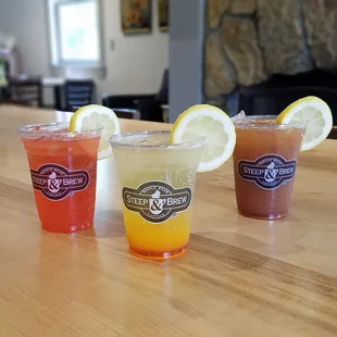 three different drinks on a table